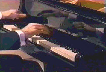 Shot of Jack Gibbons's hands playing I Got Rhythm on NBC tv show